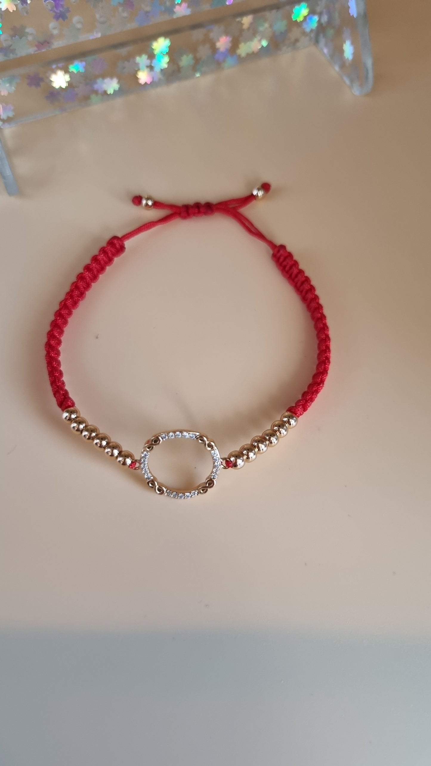 Red color bracelet with hypoallergenic waterproof beads and pendant