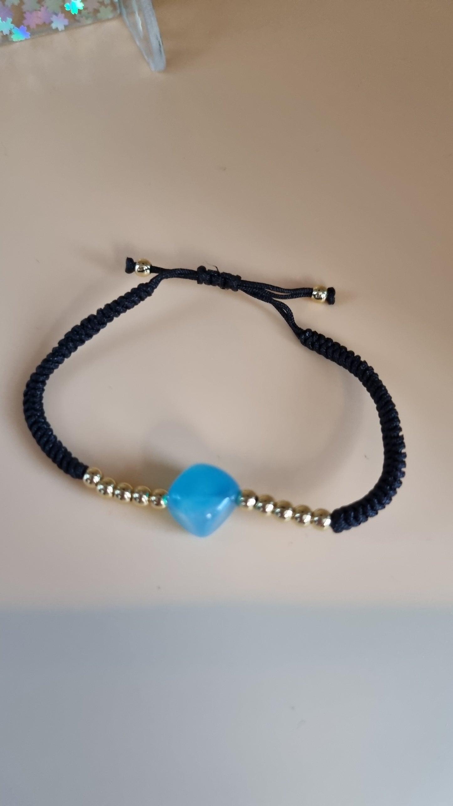 One size bracelet black color with 14.kr gold plated beads  hypoallergenic waterproof blue stone beads